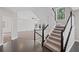 Inviting foyer with hardwood floors, staircase with black railing, and open view to the living area at 5153 Elkins Ln, Acworth, GA 30101