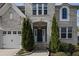 Beautiful home featuring a well-manicured front yard and a welcoming front door flanked by evergreen shrubs at 5153 Elkins Ln, Acworth, GA 30101