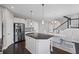 Spacious kitchen with stainless steel appliances, a large island, and an adjacent dining area with staircase access at 5153 Elkins Ln, Acworth, GA 30101