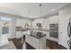 Beautiful kitchen with white cabinetry, dark countertops, stainless steel appliances, and a center island at 5153 Elkins Ln, Acworth, GA 30101