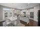 Well-lit kitchen with white cabinets, dark countertops, stainless steel appliances, and a breakfast nook with access to the yard at 5153 Elkins Ln, Acworth, GA 30101