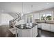 Bright, open-concept kitchen with stainless steel appliances, a central island, and an adjacent dining area with access to outdoors at 5153 Elkins Ln, Acworth, GA 30101