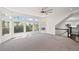 Bright and spacious living area with large windows and neutral carpeting, staircase and open floorplan at 5153 Elkins Ln, Acworth, GA 30101