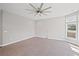Expansive living room with a large window array, modern ceiling fan, and neutral color palette at 5153 Elkins Ln, Acworth, GA 30101