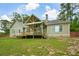 Back exterior of home featuring an expansive deck and well-manicured backyard at 773 Pebblebrook Rd, Mableton, GA 30126