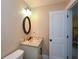 Cozy bathroom with granite countertop vanity, oval mirror, and soft lighting at 773 Pebblebrook Rd, Mableton, GA 30126