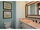 Powder room features double vanity with granite counters and stylish framed mirror at 773 Pebblebrook Rd, Mableton, GA 30126