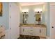 Elegant bathroom featuring a dual vanity with granite countertops and decorative mirrors at 773 Pebblebrook Rd, Mableton, GA 30126