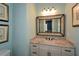 Stylish bathroom with a granite countertop and decorative framed mirror at 773 Pebblebrook Rd, Mableton, GA 30126