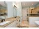 Bright bathroom featuring double sinks with granite counters and a tiled shower at 773 Pebblebrook Rd, Mableton, GA 30126
