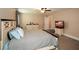 Bright bedroom with carpeting features a large bed and a view of an entertainment center at 773 Pebblebrook Rd, Mableton, GA 30126