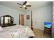 Inviting bedroom with a four-poster bed, dresser and TV at 773 Pebblebrook Rd, Mableton, GA 30126