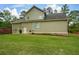 Side exterior view of the home showcasing a well-maintained lawn and the architectural details of the facade at 773 Pebblebrook Rd, Mableton, GA 30126