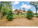 Beautiful home with lush landscaping and a manicured lawn, framed by a stone and iron fence at 773 Pebblebrook Rd, Mableton, GA 30126