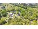 This aerial view captures two homes with pools nestled among mature trees with manicured lawns at 88 Cline Smith Ne Rd, Cartersville, GA 30121