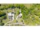 A birds-eye view shows two homes with pools on lush properties surrounded by mature trees at 88 Cline Smith Ne Rd, Cartersville, GA 30121
