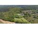 Aerial view of two homes with pools surrounded by lush trees with property lines in view at 88 Cline Smith Ne Rd, Cartersville, GA 30121