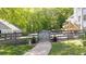 A charming backyard with a wooden fence and a playful playset visible from the gate pathway, set in a lush green lawn at 88 Cline Smith Ne Rd, Cartersville, GA 30121