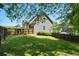 Spacious backyard featuring a lush green lawn, privacy fence, and mature trees, perfect for outdoor activities and relaxation at 88 Cline Smith Ne Rd, Cartersville, GA 30121