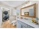 Charming bathroom with marble countertop, designer mirror, and stacked washer dryer in adjacent room at 88 Cline Smith Ne Rd, Cartersville, GA 30121