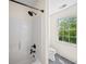 Bright bathroom features a shower-tub combination with black fixtures and a window with natural light at 88 Cline Smith Ne Rd, Cartersville, GA 30121