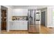 Bright kitchen features stainless steel refrigerator, white cabinets, and ample counter space for coffee bar at 88 Cline Smith Ne Rd, Cartersville, GA 30121