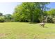 Open green pasture with mature trees on property, perfect for grazing, recreation and quiet enjoyment of country living at 88 Cline Smith Ne Rd, Cartersville, GA 30121
