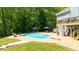Backyard oasis featuring a pool, expansive patio area, surrounded by greenery and blue skies at 88 Cline Smith Ne Rd, Cartersville, GA 30121
