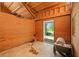 A utility shed with wood paneling, an open door, and a concrete floor; the shed would be suitable for horses or other farm animals at 88 Cline Smith Ne Rd, Cartersville, GA 30121
