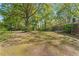Expansive backyard showing the home with patio; lawn and mature trees at 1788 Hammond Woods Sw Cir, Marietta, GA 30008