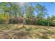 Backyard view of a single-story brick home; trees provide shade at 1788 Hammond Woods Sw Cir, Marietta, GA 30008