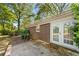View of backyard and brick home with patio and a set of French doors at 1788 Hammond Woods Sw Cir, Marietta, GA 30008
