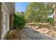 View of the backyard from the concrete patio with a set of French doors at 1788 Hammond Woods Sw Cir, Marietta, GA 30008