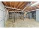 Unfinished basement with concrete floor, exposed pipes, and stairway to upper level at 1788 Hammond Woods Sw Cir, Marietta, GA 30008
