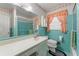 Vintage bathroom with turquoise tile, white vanity, and shower-tub combo at 1788 Hammond Woods Sw Cir, Marietta, GA 30008