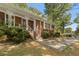 Close-up of a brick home entrance, showcasing a decorative white railing and mature landscaping at 1788 Hammond Woods Sw Cir, Marietta, GA 30008