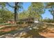 Charming brick home featuring a long driveway and mature trees on a sunny day at 1788 Hammond Woods Sw Cir, Marietta, GA 30008