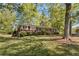Traditional brick home with white trim, nestled among mature trees and a green lawn at 1788 Hammond Woods Sw Cir, Marietta, GA 30008