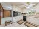 Kitchen features white cabinets, tile floors, stainless appliances and breakfast nook overlooking backyard at 1788 Hammond Woods Sw Cir, Marietta, GA 30008