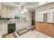 Cozy kitchen featuring white cabinetry, tiled floors, and natural light from a window at 1788 Hammond Woods Sw Cir, Marietta, GA 30008