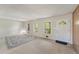 Spacious living room with carpet, large windows, and a neutral color palette at 1788 Hammond Woods Sw Cir, Marietta, GA 30008