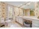Elegant bathroom featuring custom wallpaper, a vanity with ample storage, and a door to the exterior at 2769 Peachtree Ne Rd # 6, Atlanta, GA 30305
