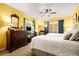 Bright bedroom features two beds, ceiling fan, and a dresser with decorative mirror at 2769 Peachtree Ne Rd # 6, Atlanta, GA 30305