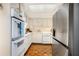 Well-lit kitchen with white cabinets, stainless steel refrigerator and unique parquet wood flooring at 2769 Peachtree Ne Rd # 6, Atlanta, GA 30305