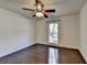 Bedroom with hardwood floors, ceiling fan, and a single window at 4640 Lambton Cir, Suwanee, GA 30024