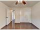 Spacious bedroom with hardwood floors, ceiling fan, and closet space at 4640 Lambton Cir, Suwanee, GA 30024