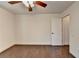 Bedroom featuring a ceiling fan, hardwood floors, and neutral decor at 4640 Lambton Cir, Suwanee, GA 30024