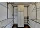 Well-organized walk-in closet with custom shelving, cabinetry, and ample storage space for clothing and accessories at 4640 Lambton Cir, Suwanee, GA 30024