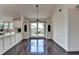 Eat-in kitchen with large windows, custom built-ins, and hardwood floors at 4640 Lambton Cir, Suwanee, GA 30024
