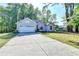 One-story home with a concrete driveway and a well-manicured lawn at 4640 Lambton Cir, Suwanee, GA 30024
